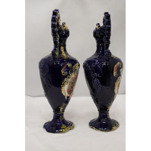 114 - A PAIR OF VICTORIAN VASES IN COBALT BLUE WITH PICTORIAL DECORATION, HEIGHT 41 CM