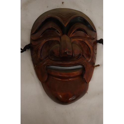 128 - TWO WALL MASKS TO INCLUDE A JAPANESE ONE WITH MARKS TO INNER AND A NEW ZEALAND 'KORURU', 'RURU' IS M... 