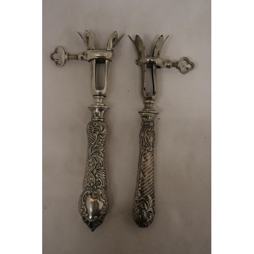 133A - TWO VINTAGE CONTINENTAL, POSSIBLY SILVER, HANDLED GIGOT LAMB SHANK/HAM BONE HOLDERS
