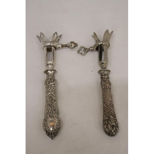 133A - TWO VINTAGE CONTINENTAL, POSSIBLY SILVER, HANDLED GIGOT LAMB SHANK/HAM BONE HOLDERS