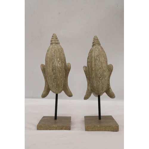 135 - TWO BUDDAH HEADS ON STANDS, HEIGHT 27CM