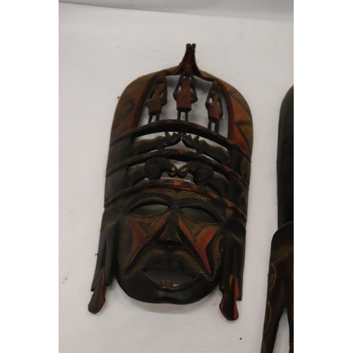 142 - TWO AFRICAN 'TRIBAL STYLE', CARVED WOODEN WALL MASKS