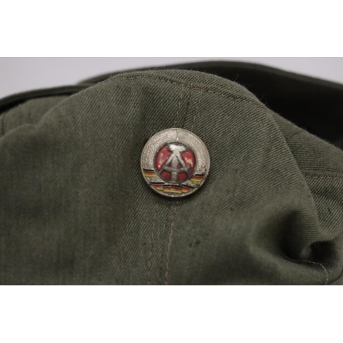 149 - A 1950'S EAST GERMAN MILITARY CAP AND BADGE