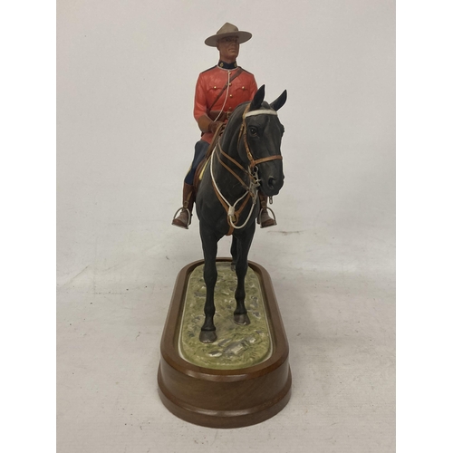 712 - A ROYAL WORCESTER MODEL OF A ROYAL CANADIAN MOUNTED POLICEMAN  MODELLED BY DORIS LINDNER AND PRODUCE... 