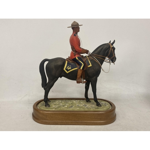 712 - A ROYAL WORCESTER MODEL OF A ROYAL CANADIAN MOUNTED POLICEMAN  MODELLED BY DORIS LINDNER AND PRODUCE... 