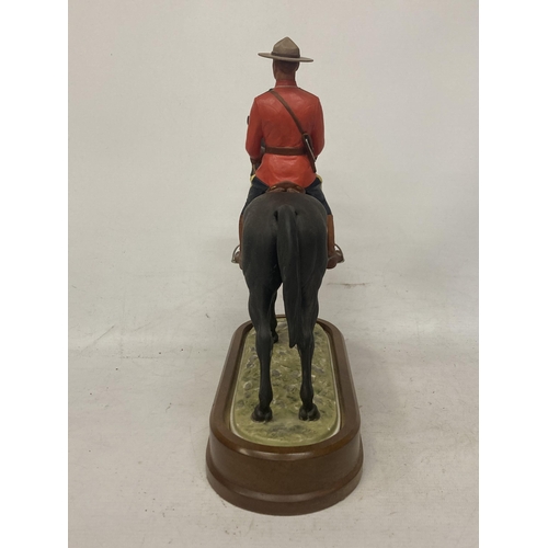 712 - A ROYAL WORCESTER MODEL OF A ROYAL CANADIAN MOUNTED POLICEMAN  MODELLED BY DORIS LINDNER AND PRODUCE... 