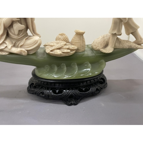 190 - AN ORIENTAL CARVING OF FISHERMEN ON A POSSIBLY JADE BOAT, HEIGHT 20CM, WIDTH 27CM