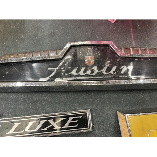 196 - SEVEN VINTAGE CAR BADGES TO INCLUDE THE AA, AUSTIN, ETC