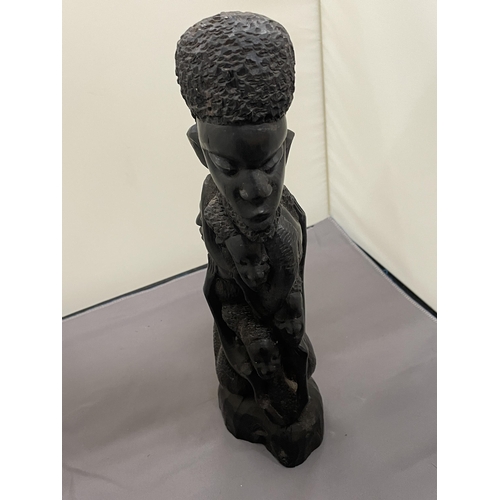 198 - A DARK WOOD, POSSIBLY EBONY, TRIBAL STYLE CARVING, HEIGHT 30CM