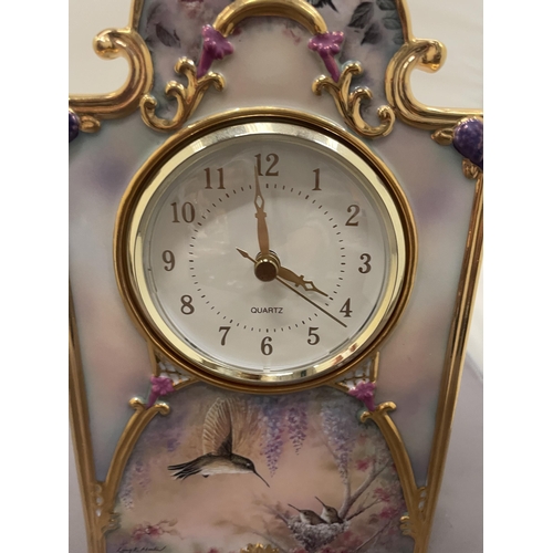 233 - A DECORATIVE CERAMIC PORCELAIN HEIRLOOM CLOCK, WITH HUMMING BIRD DESIGN, BY LARRY K MARTIN