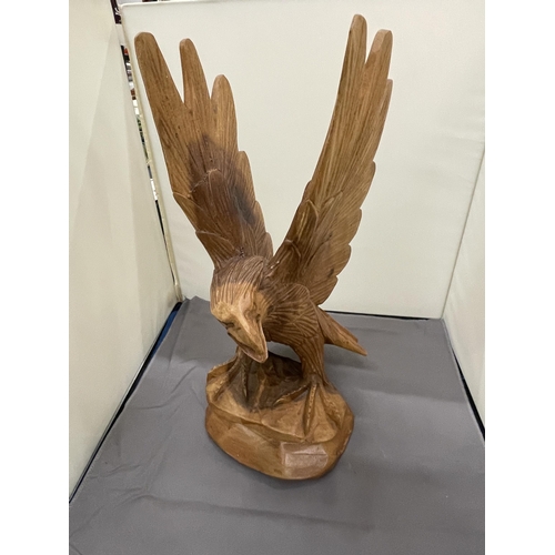 243 - A HAND CARVED WOODEN EAGLE, HEIGHT 37CM