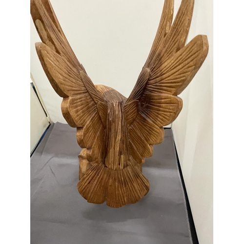 243 - A HAND CARVED WOODEN EAGLE, HEIGHT 37CM