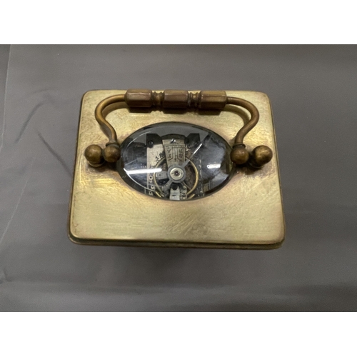 251 - A VINTAGE BRASS CARRIAGE CLOCK WITH BEVELLED GLASS REVEALING THE INNER WORKINGS