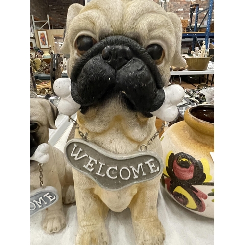 255 - A MUMMY PUG AND PUPPY, 'WELCOME HOME' FIGURES, HEIGHTS 29CM AND 20CM