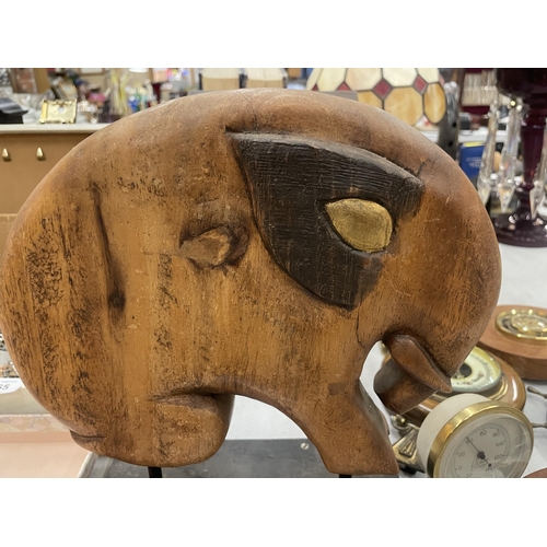 263 - A CARVED HARDWOOD ELEPHANT ON A PLINTH, 29CM X 20CM