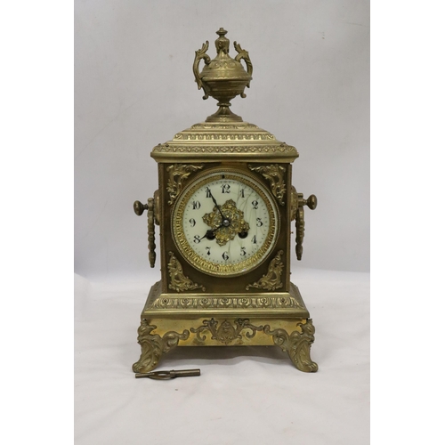 8 - A FRENCH GILT BRASS MANTLE CLOCK WITH KEY