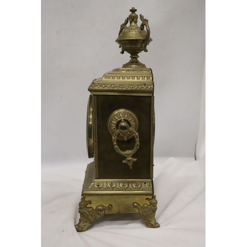 8 - A FRENCH GILT BRASS MANTLE CLOCK WITH KEY