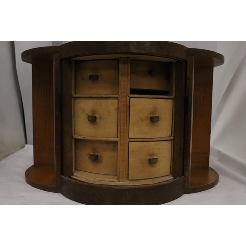 20 - AN ART DECO STYLE WALNUT BOW FRONTED JEWELLERY BOX WITH TUBE SLIDING DOORS AND SIX INNER DRAWERS 47C... 