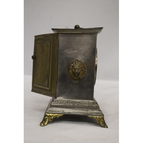 18 - AN ORNATE VINTAGE ALARM CARRIAGE CLOCK WITH LION HANDLE DECORATION TO THE SIDES - POSSIBLY AN OFFICE... 
