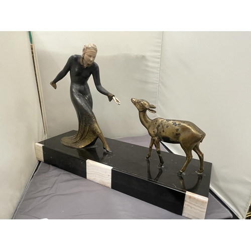 59 - AN ART DECO STYLE BRASS FIGURE OF LADY FEEDING A FAWN. SET ON A BASE (LADIES HAND A/F)