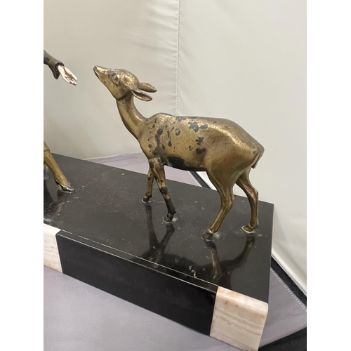 59 - AN ART DECO STYLE BRASS FIGURE OF LADY FEEDING A FAWN. SET ON A BASE (LADIES HAND A/F)
