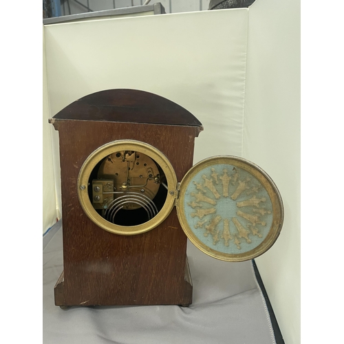 63 - A MAHOGANY INLAID MANTLE CLOCK WITH INSCRIPTION PLATE (A/F LEG MISSING)