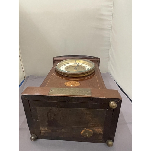 63 - A MAHOGANY INLAID MANTLE CLOCK WITH INSCRIPTION PLATE (A/F LEG MISSING)