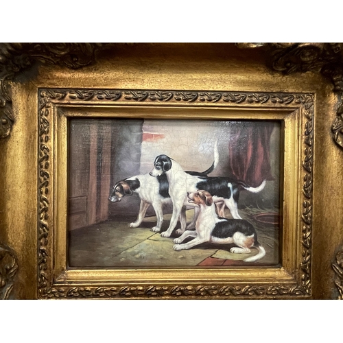 64 - A PRINT OF THREE DOGS IN A HEAVY GILDED FRAME PRINT SIZE 18CM X 12CM