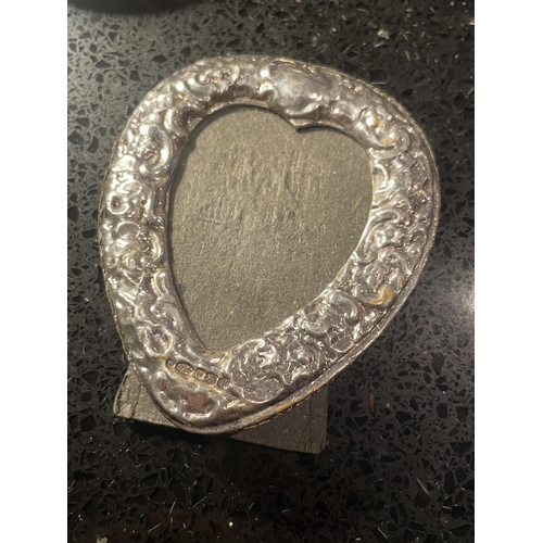 93 - THREE MINIATURE HALLMARKED SILVER PHOTOGRAPH FRAMES TO INCLUDE A DECORATIVE HEART SHAPED EXAMPLE
