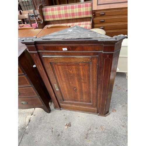 2650 - A GEORGE III OAK AND MAHOGANY INLAID CORNER CUPBOARD WITH SHAPED INTERIOR SHELVES