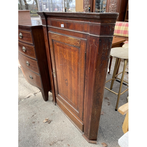 2650 - A GEORGE III OAK AND MAHOGANY INLAID CORNER CUPBOARD WITH SHAPED INTERIOR SHELVES