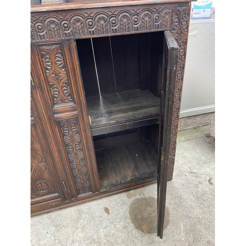 2655 - AN OAK GEORGE III STYLE COURT CUPBOARD WITH CARVED PANELS, THREE DEPICTING THE BIRTH AND CRUCIFIXION... 