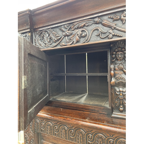 2655 - AN OAK GEORGE III STYLE COURT CUPBOARD WITH CARVED PANELS, THREE DEPICTING THE BIRTH AND CRUCIFIXION... 