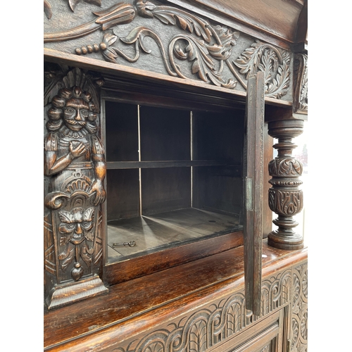 2655 - AN OAK GEORGE III STYLE COURT CUPBOARD WITH CARVED PANELS, THREE DEPICTING THE BIRTH AND CRUCIFIXION... 