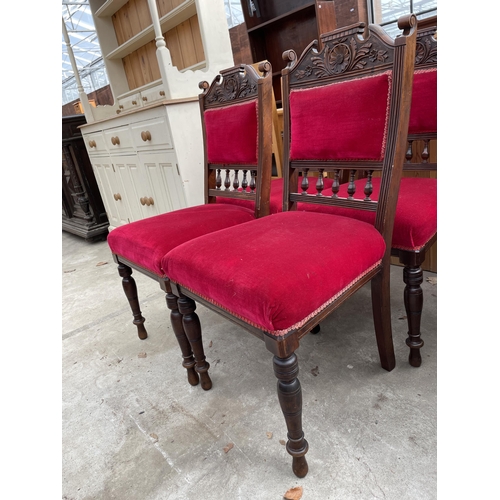 2666 - A SET OF FOUR LATE VICTORIAN UPHOLSTERED DINING CHAIRS WITH CARVED TOP RAILS AND TURNED FRONT LEGS