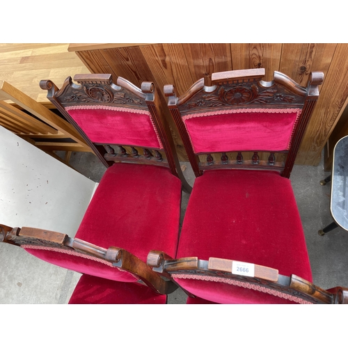 2666 - A SET OF FOUR LATE VICTORIAN UPHOLSTERED DINING CHAIRS WITH CARVED TOP RAILS AND TURNED FRONT LEGS