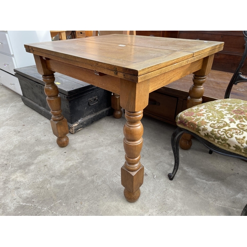 2670 - A MID 20TH CENTURY OAK FOLD OVER TABLE