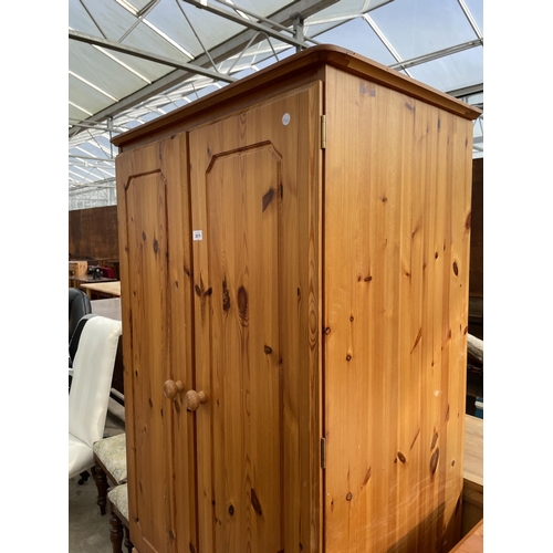 2675 - A PINE TWO DOOR WARDROBE WITH TWO DRAWERS TO BASE