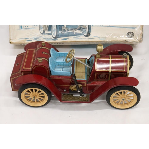 392 - A VINTAGE BOXED, BATTERY OPERATED, TIN PLATE CAR