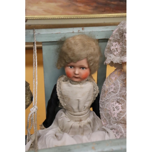 398 - A VINTAGE DOLL'S COT WITH THREE DOLLS, ONE A PALITOY AND A TEDDY BEAR