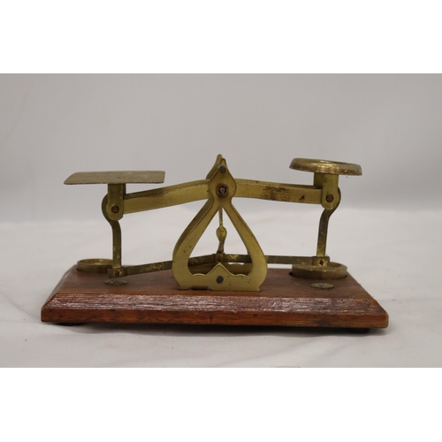 845 - AN ANTIQUE POSTAL SCALE BRASS AND WOOD BASE