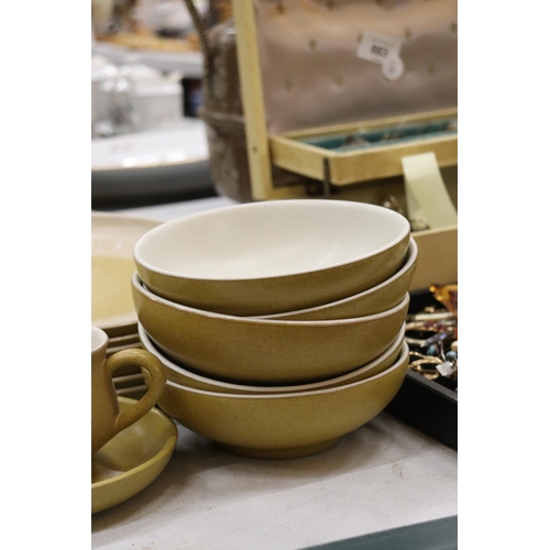 884 - A DENBY MUSTARD COLOURED DINNER SERVICE, TO INCLUDE VARIOUS SIZES OF PLATES, A CASSEROLE DISH, BOWLS... 