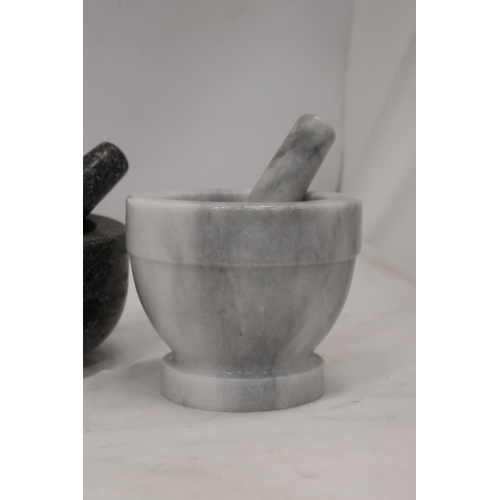 904 - THREE HEAVY PESTLE AND MORTARS TO INCLUDE TWO MARBLE AND A CAST ONE