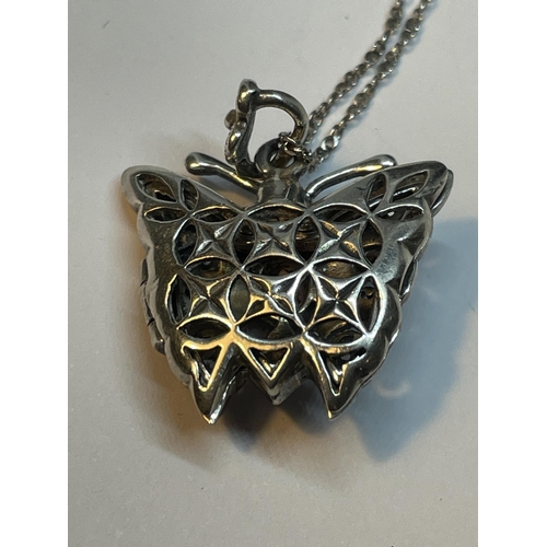 678 - A MARKED 925 SILVER ORNATE BUTTERFLY LOCKET ON A CHAIN