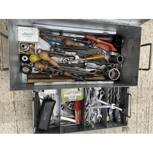 1729 - A METAL TOOL BOX WITH AN ASSORTMENT OF TOOLS TO INCLUDE SPANNERS, DRILL BITS AND PLIERS ETC