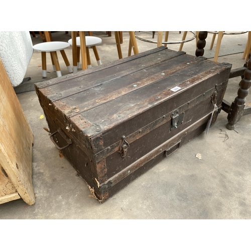 2908 - A VICTORIAN CONMPRESSED FIBRE TRAVELLING TRUNK WITH WOODEN SLATS AND METAL FITTINGS