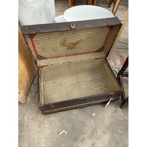 2908 - A VICTORIAN CONMPRESSED FIBRE TRAVELLING TRUNK WITH WOODEN SLATS AND METAL FITTINGS