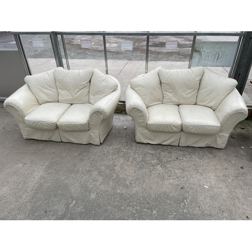 2974 - A PAIR OF CREAM SETTEES