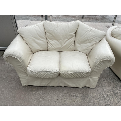 2974 - A PAIR OF CREAM SETTEES