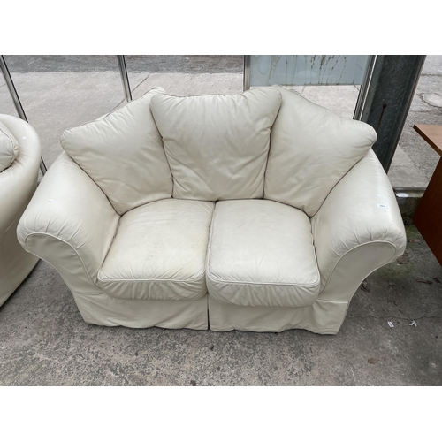 2974 - A PAIR OF CREAM SETTEES